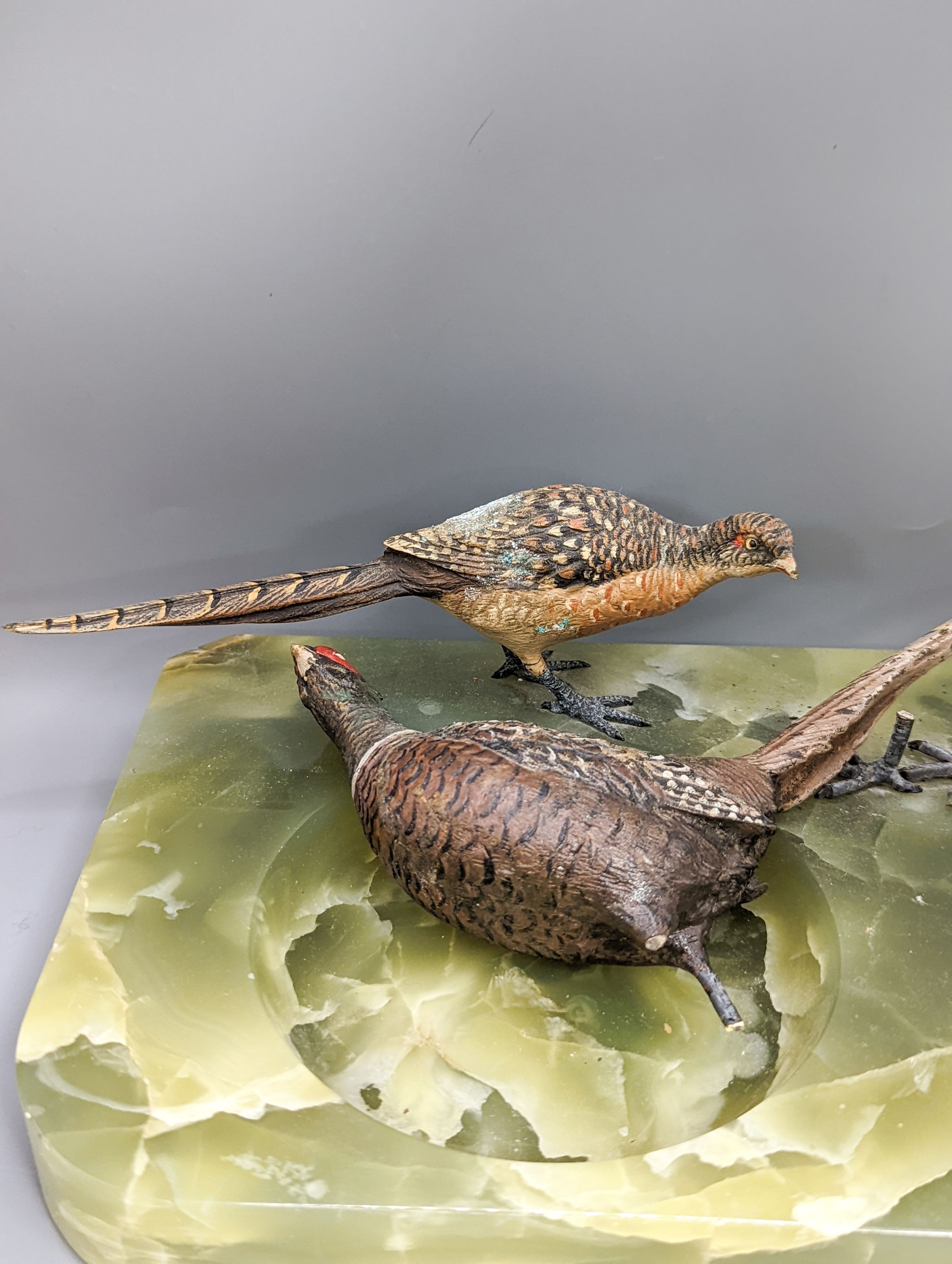 A green onyx ash stand, mounted with cold painted bronze pheasants and another, mounted with a model of an owl (2)